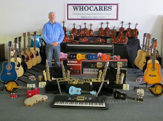 Tim Irving and the instruments collected for Armenian music school.