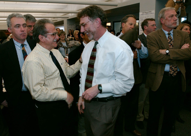 Boston Globe editor Marty Baron congratulates Stephen Kurkjian after the newspaper was awarded a Pulitzer Prize in Boston, Monday April 7, 2003. 